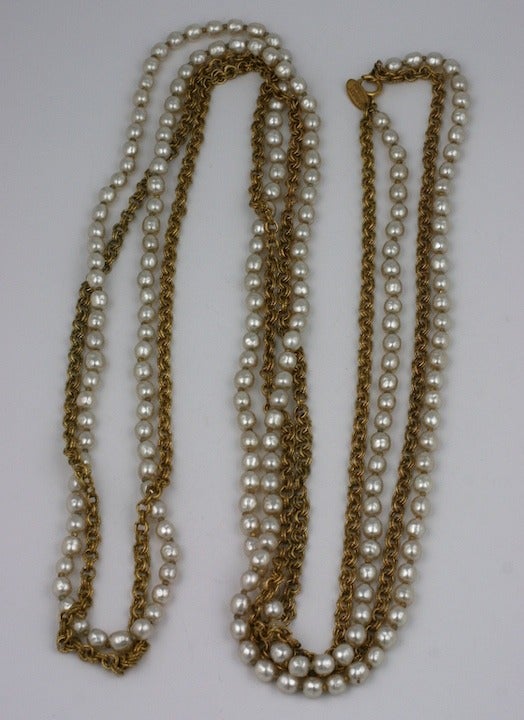 Long versatile rope necklace of gilt chain and pearls to wrap as desired by MIriam Haskell. Signature Russian gold finish and pearls. 60