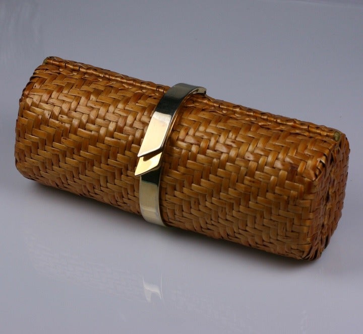 Wicker tubular clutch with oversized bracelet latch. Retractable gilt wrist chain inside. Rolo, Made in USA, 1980s.
Excellent condition.