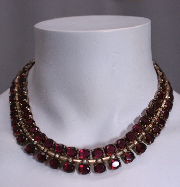 Wonderful Trifari gold washed sterling silver retro demiparure circa 1940. Set with oval cut garnet pastes. Can be worn as bracelet and necklace or as an extra long necklace. Superb quality in the heavy settings, 1940s USA.
Excellent