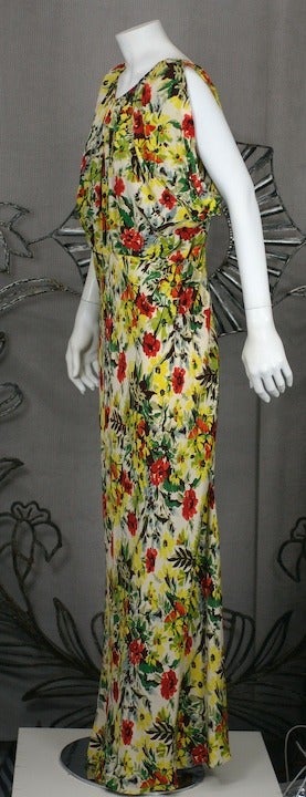 Floral printed silk crepe gown with waist and draped bodice. The neckline is gathered and the fullness is caught under the arms with draped tucks. There is an underbodice (like a silk tank) holding the front draping in place and the back is open to