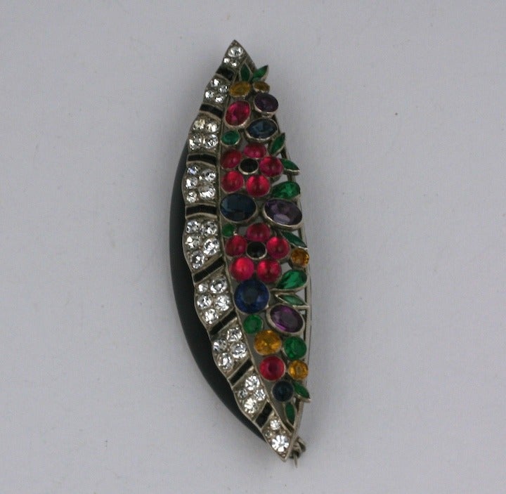 Art Deco paste brooch set in sterling with enamel and glass stone flowers in the Cartier fruit salad style. Amazing quality with onyx channel set stones within the pave rim and bezel set colored paste flowers above. 2.75