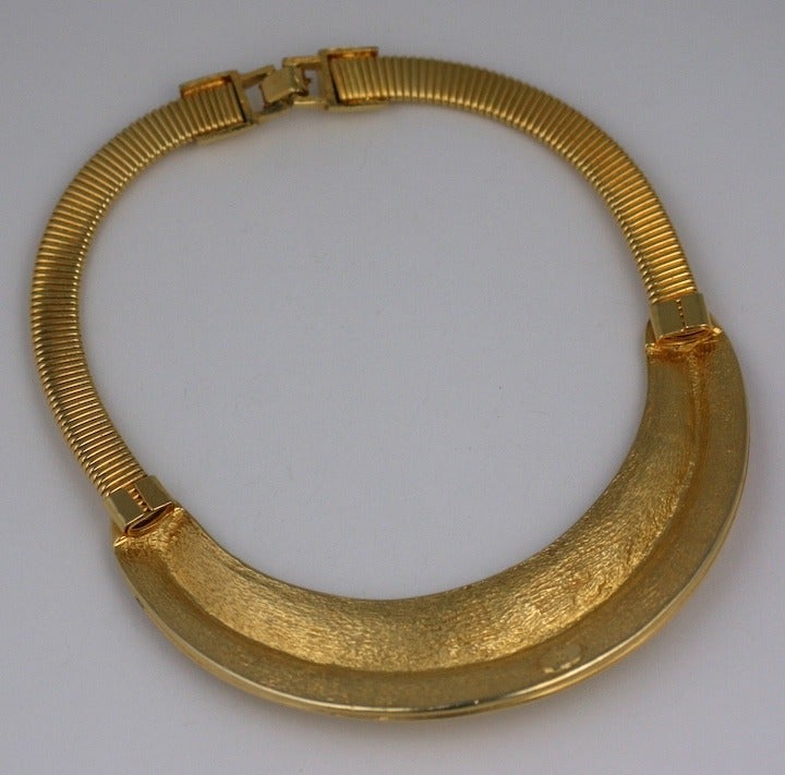 Striking collar by Alexis Kirk with African overtones. Goldtoned metal with gas pipe tubing. 1980's USA. 15