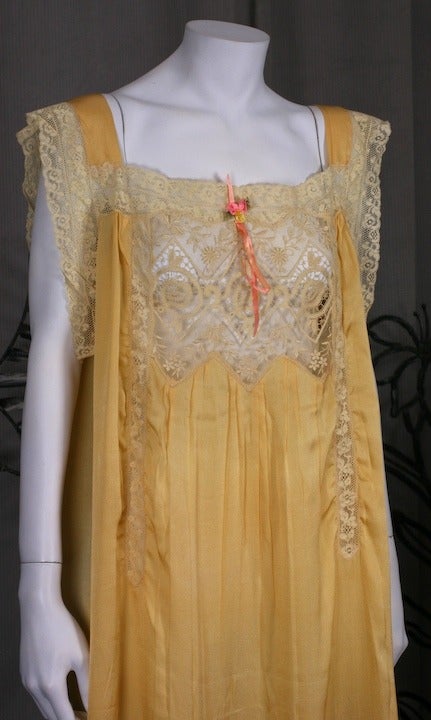 Marigold silk crepe lingerie gown with lace insertions and rosebud decoration. Handkerchief point hem with lace trim. Easily belted and worn as summer dress. 1920's USA.
50