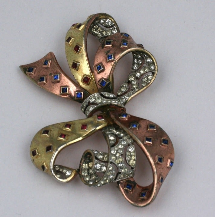 Unusual and rare Trifari 2 toned retro bow brooch. Pink and yellow gold are mixed with sapphire and ruby square cut pastes with openwork pave. 3