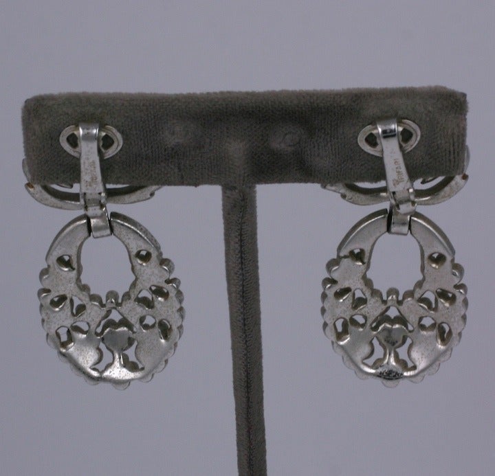 Unusual pave earrings by Trifari with leaf and floret motifs. The hoops are made of tiny flower buds and move independantly from the leaf motif on ear. USA 1950's. Excellent condition.