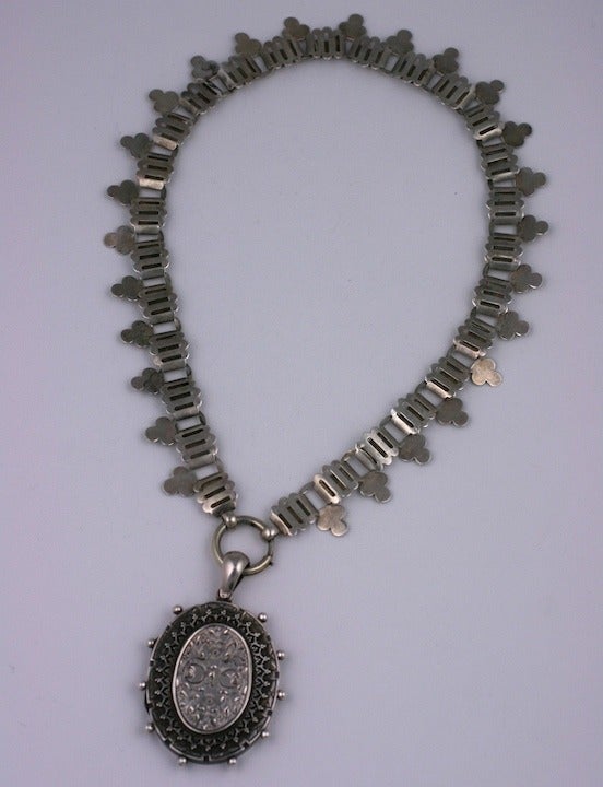 19th Century locket and chain of clover leaf links in sterling. Heavily engraved locket with ball decoration. 15.5