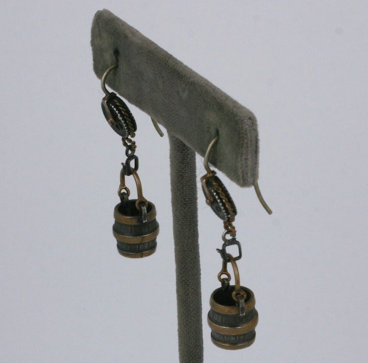 Rare figural novelty earrings from the late 19th Century of silver and brass bound wishing wells falling from pulleys. Exceptional and extraordinary detailing. Imagine the reaction when these were worn 125 years ago.  1.5