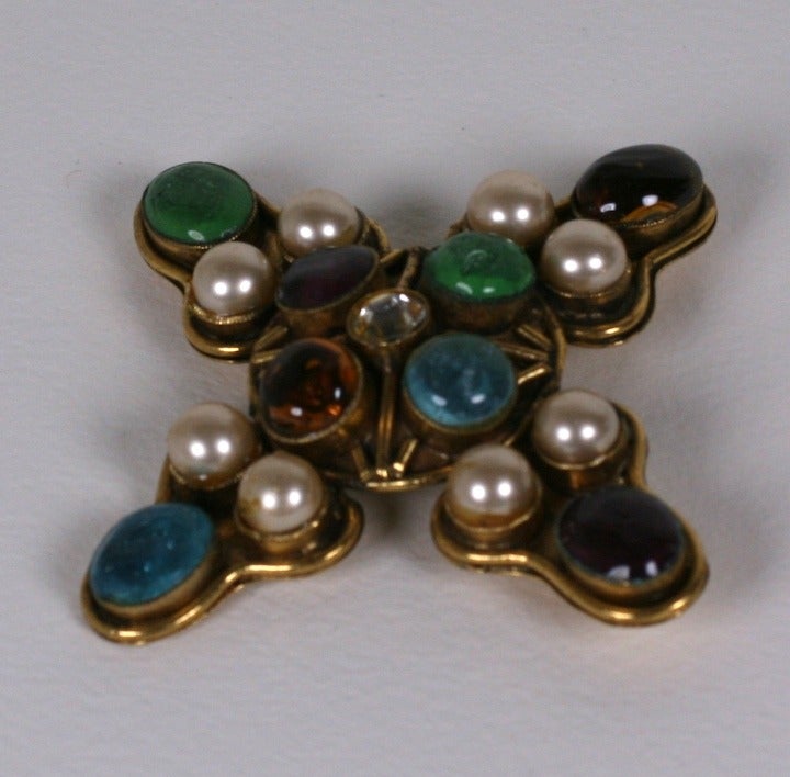 Chanel by Goossens handmade cross in pate de verre, faux pearls and bronzed metal. Softer uncharacteristic Chanel tones including aquamarine and pale emerald decorate this brooch. A chain can slide through the pin closure so it can be worn as a