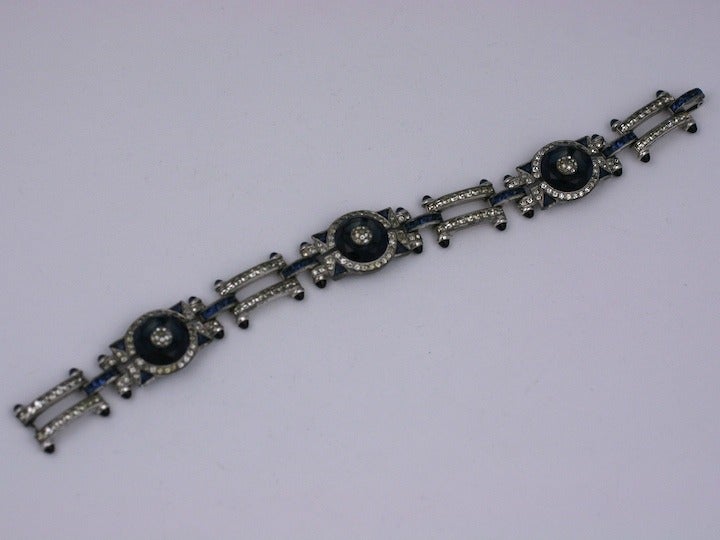 High style art deco bracelet with unusual cut stones in faux sapphires and crystal. Triangular cut faux sapphires and facet cut discs with pave centers. The links of the bracelet have sapphire cab terminals with square cut sapphire connectors.