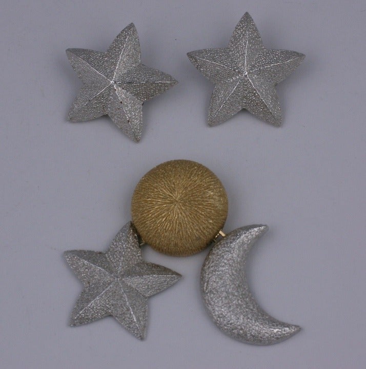 Christian Dior sun, moon and stars suite in textured silver and gilt metal. The brooch is articulated so the other motifs dangle from 