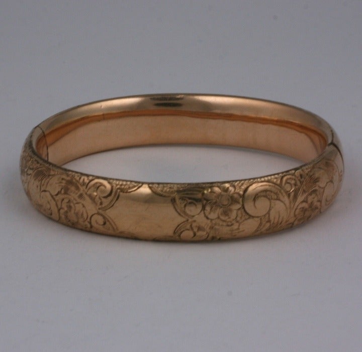 Attractive Victorian gold filled bangle with etched floral detailing. Late 19th Century. Side opening hinged closure opening. Width .5