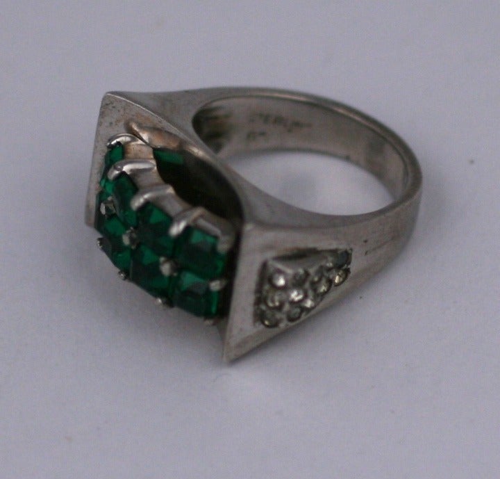 Striking Retro sterling cocktail ring set with a double row a square cut faux emeralds with pave accents on the shoulders. 
Sterling by Marcel Boucher, unsigned, USA 1940's. Size 6.