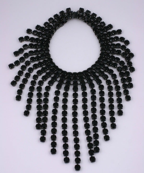 Scooter had boutiques throughout France in the 1980s and 90s making large statement jewelry encrusted with rhinestones. This large dramatic bib is made of hundreds of hand set jet pastes in articulated settings. Very striking and beautifully made.