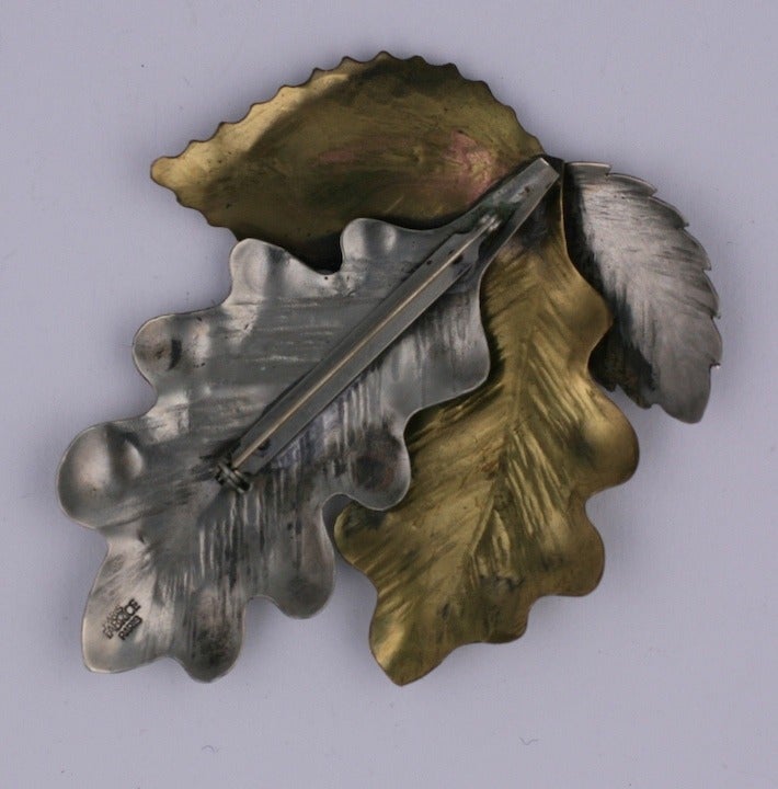 Oak leaf brooch by Fabrice, Paris in silvered and brass toned metal. Leaves are hand raised and detailed. France 1990's.  3.5