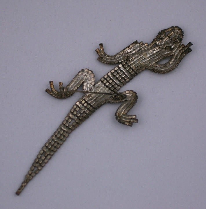 Charming lizard brooch from the 1980s designed to be worn over the shoulder. The body is articulated and flexible so the brooch can be worn almost anywhere. There are 2 pin back fittings used to attach to garment. Many of these were made by Butler