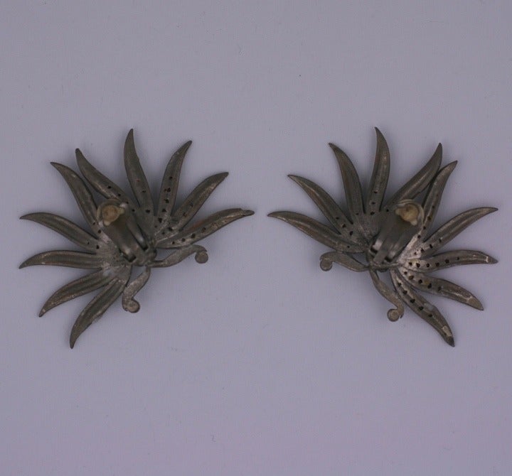 Large scale French earrings of palm leaves with pave work centering a large navette crystal. Clip back fittings. France 1980's. 2.5