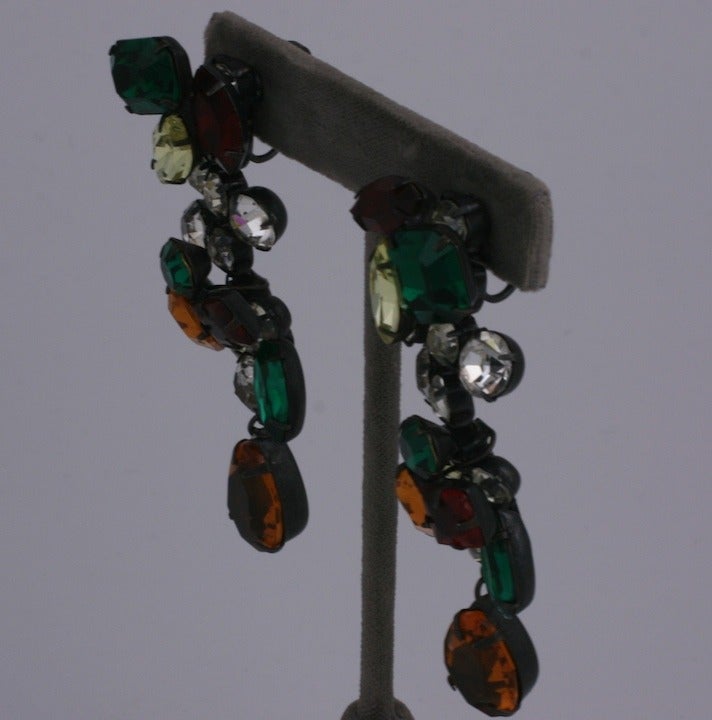 Striking Swarovski crystal earrings from YSL in various shades of ruby, emerald, citrine and crystal. The stones settings are staggered to give the earring dimension and interest. The metal is a blackened japanned finish for contrast. Clip back