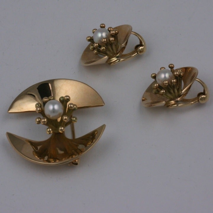 Danish Modernist suite in 14K gold with cultured pearls by Ole Lynggaard Denmark. The pearls are surrounded by little abstract buds on a base which is somewhat tribal in inspiration. Earrings have clip back fittings (1