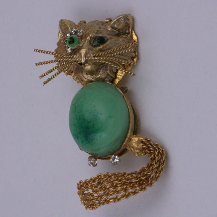 Maison Gripoix 's whimiscal  version of  Van Cleef & Arpels famed winking cat brooch with a poured glass green emerald eye accented with sparkling crystal pastes and an oval pate de verre jade cabochon belly. A unique and rare circa 1950s design