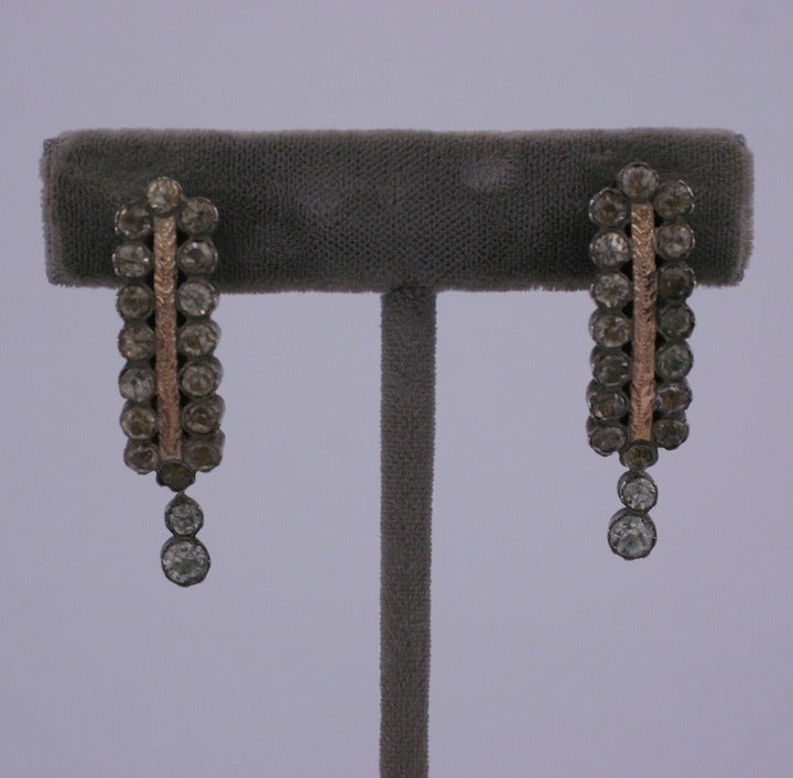 Attractive paste earrings from the late 19th Century set in sterling silver. A strip of etched gilt metal runs between the pastes. Screw back fittings. France 1890's made in an earlier Georgian style. 1.5