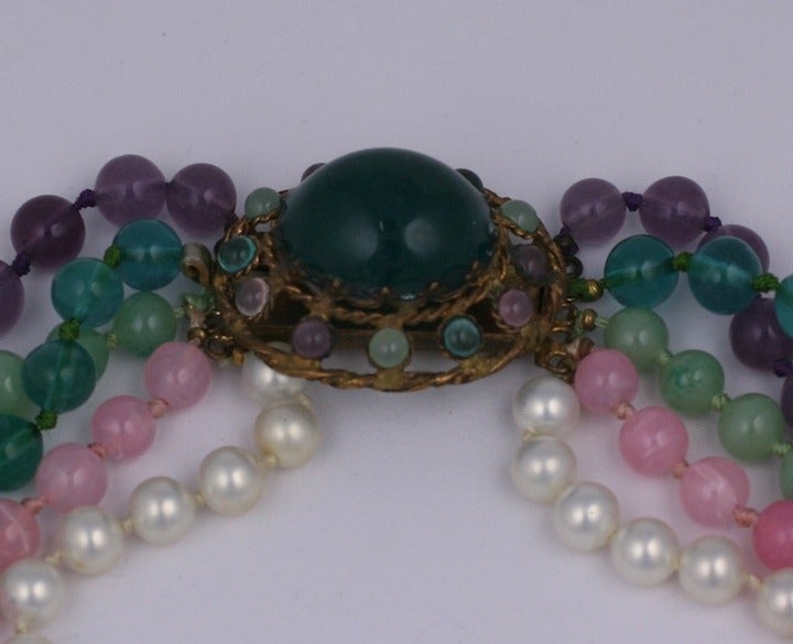 Maison Gripoix for Chanel multi strand necklace with matching poured glass clasp with   faux pearl , amythest, jade.emerald ,and rose quartz  pate de verre handmade beads. France 1930's.The oval hand made gilt clasp repeats the colors of the bead