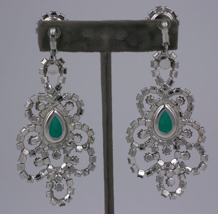 Large rhinestone earrings in crystal and emerald pastes by Hattie Carnegie circa 1960's. Large and imposing design in the antique taste with clip back fittings. 1960's USA. 3.75