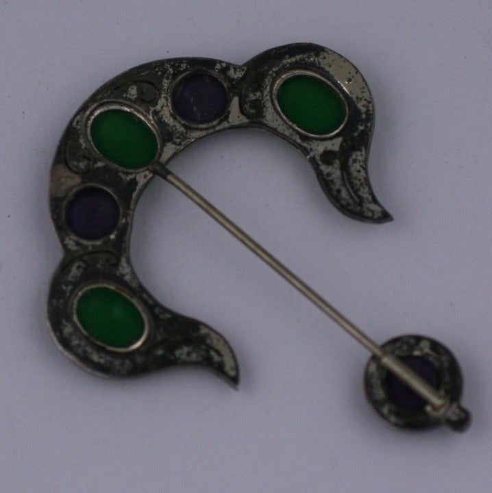 Attractive Art Deco Jabot pin in the Moorish taste with emerald and amythest glass cabochons surrounded with crystal pastes set in sterling silver. Pin slides through fabric so only the motifs remain visible. 1920's USA.  2.5