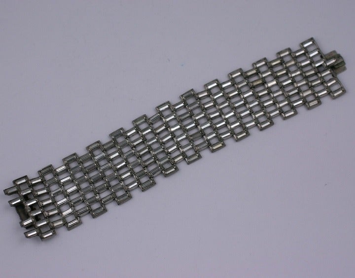 Unusual Art Deco bracelet composed entirely of rhinestone baguette stations. Very clean modern look with only stones showing in almost invisible settings. Striking width as well. 6.75