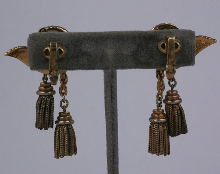 Trifari tassel earrings from the late 1940's. A pair of tassels falls assymetrically from each swirl motif ear clip set in rose finish gold. Clip back fittings. 1940's USA. Excellent condition.  2