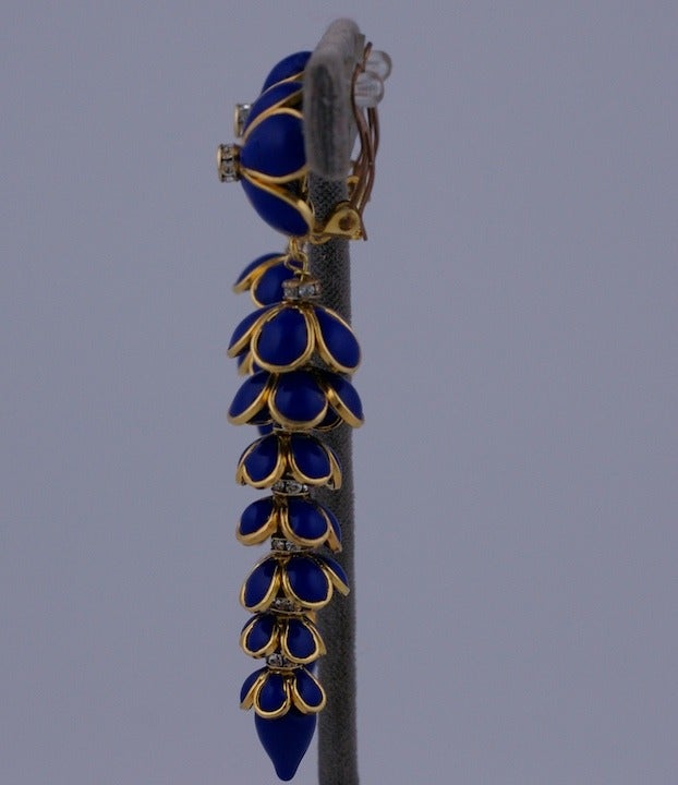 MWLC handmade tiered flower earrings in lapis poured glass enamel. These are made in couture tradition of handmade runway jewelry. Every metal bezel is hand formed and each glass petal is hand poured into its individual setting. Pave rhinestone