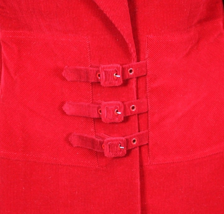 Statement blazer by Chloe, Paris of tomato red corduroy with unusual triple buckle closures. A wide band of bias cut corduroy circles the waist and anchors the buckles. Cut with strong shoulders and close to body with slim sleeves. Size Eu 38. 