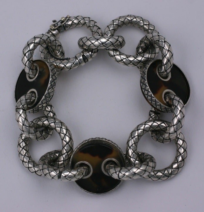 Elegant link bracelet from Bottega Veneta from their Intrecciato series replicating woven leather. This elegant sterling silver bracelet is set with 3 contrasting faux tortoise links. Striking large links and scale. 
Excellent condition. 9