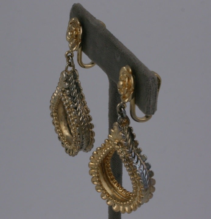 Napier 1940's  tear drop hoop earclips in gilded sterling.The three dimensional tear drop with elaborate side gallery is  suspended from a clip back flower head.
2