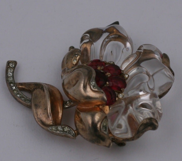 Rare Trifari camellia brooch in gold washed sterling with rhinestones, cut ruby ovals and molded lucite petals. Alfred Phillipe who worked at Cartier before designing for Trifari created this spectacular collectible 