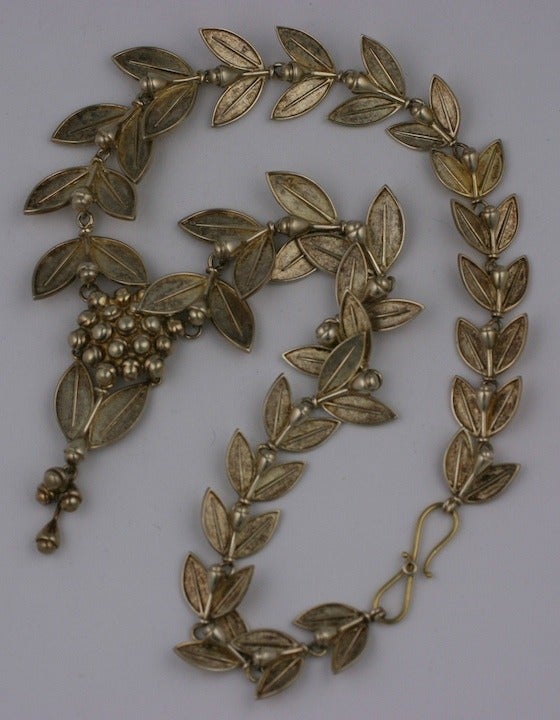 This sterling necklace of laurel leaves and berries is based on a suite of jewelry produced by Italian jeweler Carlo Guiliano circa 1863 in the classical taste.
The original suite is in high carat gold as a parure with tiara, necklace, bracelet and