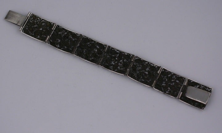 Beautifully hand crafted sterling bracelet with leaf motifs throughout. Each link is framed and swirls of wire form the bed for the individual leaves which are individually applied on top. Laborious and exquisite craftsmanship. 1950's USA. 6.5