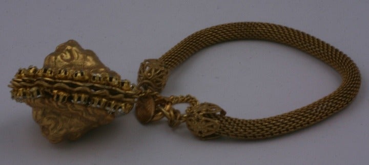 Miriam Haskell mesh charm bracelet with double sided lion heads surrounded by pastes. Signature Russian gold plating with safety clasp. 1950's USA. Signed Miriam Haskell.  7.25