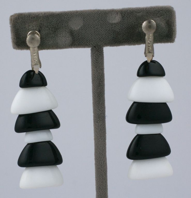 Miriam Haskell striking black and white pate de verre glass caps form the alternating pagoda form of these earrings...set in silvered metal. They measure 2.5