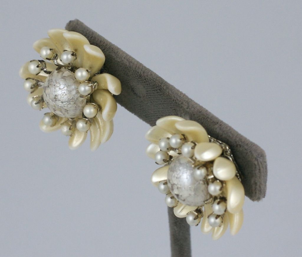 Miriam Haskell summer flower head earclips of textured white centers and candlelight pearl petals.<br />
Clip backs<br />
Excellent condition<br />
1.5