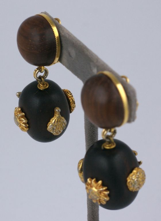 Dominique Aurientis was a prominent french jewelry designer working in Paris in the 80s and 90s. She designed bold striking jewels which have become collectible today. These earrings feature wood beads studded with gilt motifs such as a sunflower
