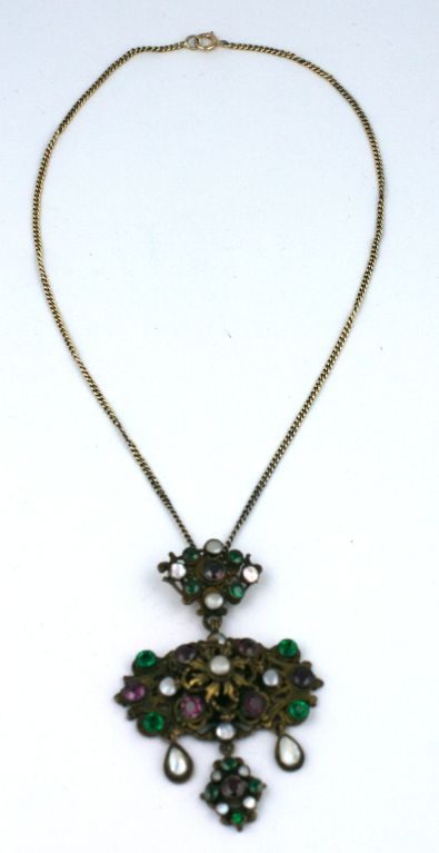 Lovely pendant of gilt silver set with amythest and emerald pastes and mother of pearl stones. Articulated drops and lovely quality. Late 19th Century.<br />
Excellent condition<br />
Pendant Length: 2.75