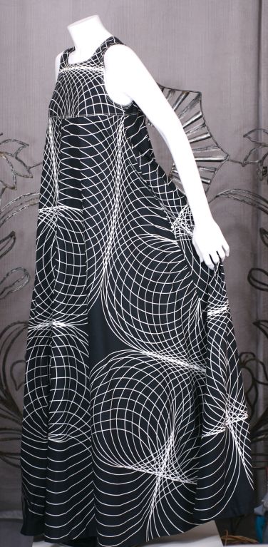 Circular graphic print in black and white. Expansive circular cut and sweep falling from yoke. Canvas printed with optic white on black circles. If laid out flat, this dress would form an immense circle held by the shoulder yoke.<br />
Slip over
