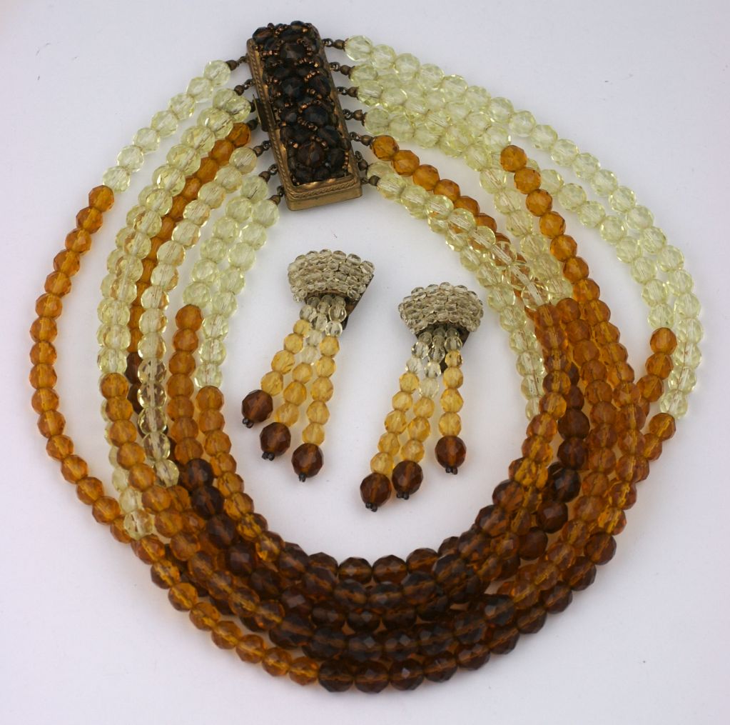 Important suite by Coppola & Toppo, Italy. Varied tones of citrine and topaz are used in this signature crystal bib. Earclips are wired and tasselled in a similar coloration.<br />
Earrings: 3