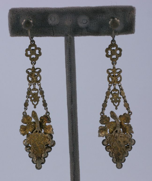 Lovely sterling paste earrings set with faux sapphires in a grape cluster design. Gilt silver florets form the connectors for the earrings. Made in Hungary,late 19th, early 20th century. <br />
Excellent condition<br />
3" x 3/4" with