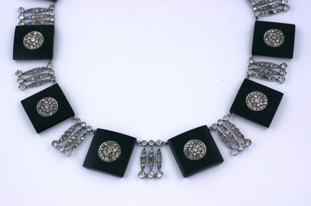 Unusual Bakelite and sterling necklace set with pastes from the 1930s. Black bakelite squares are set with pave ronds and triple navette spacers. The motif is 12