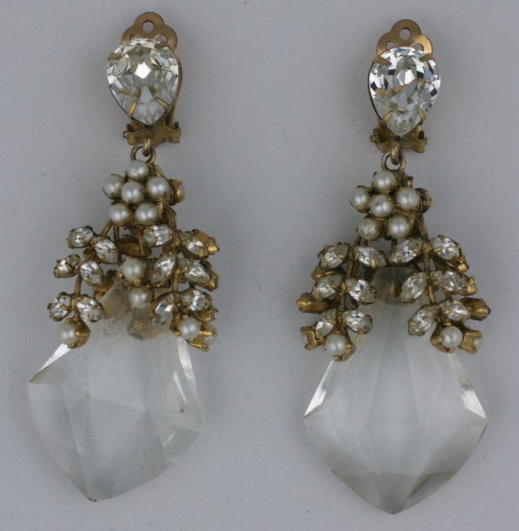 Wonderful earrings from the 1960s attributed to Schreiner NY.<br />
Crystals and faux pearls highlight the mounts of the lucite crystal which are facetted to look like chandelier crystals. Great scale.Unsigned with clip back fittings. 3