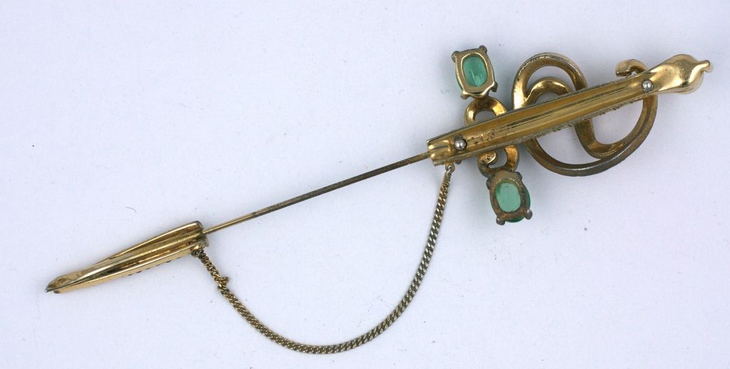 Large Jomaz jabot pin set with pastes, pearls and faux emeralds from the 1950s. Large sword motif on gilt metal, great on coat or jacket.<br />
Excellent condtion<br />
5.75