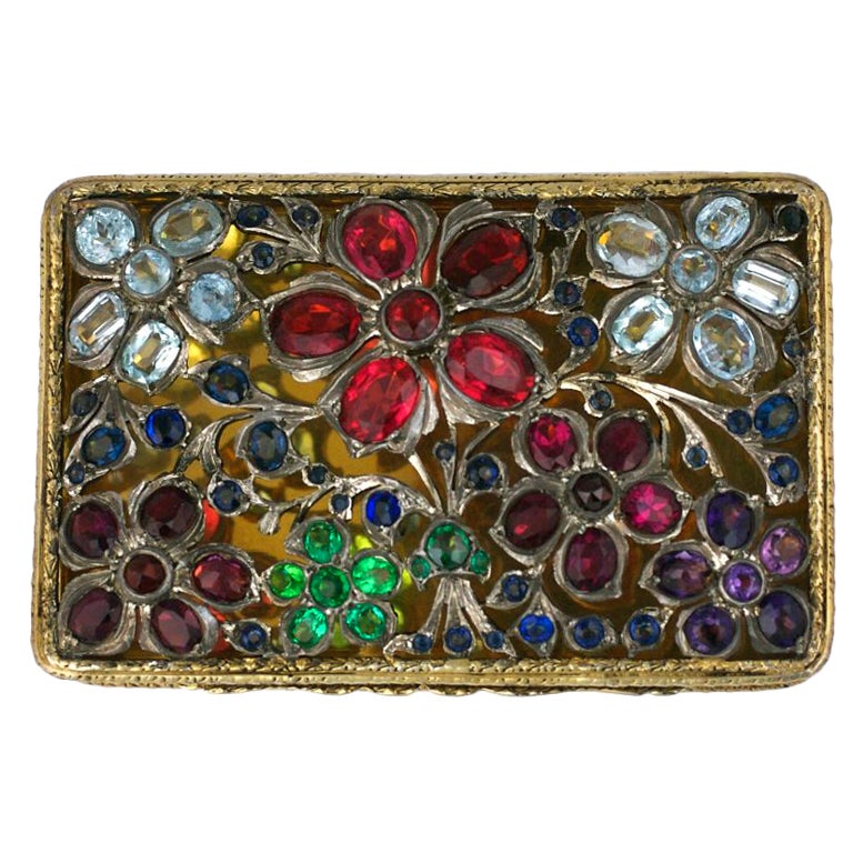 Beautiful box from the late 19th Century completely covered with colorful genuine gems and semiprecious stones. Garnets, aquamarines, sapphires and amythests are just some of the stones used in the openwork floral patterned cover. The interior of
