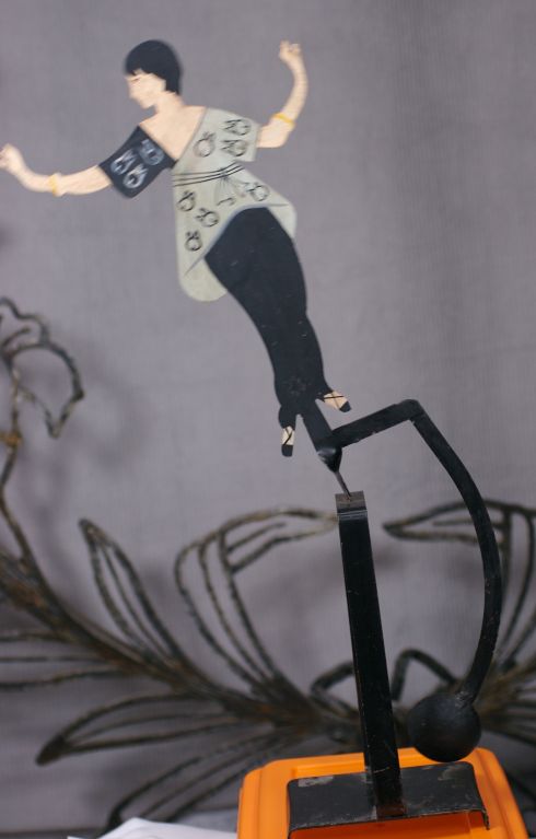 A perfect mixture of fashion and the decorative arts. An image by Georges Lepape originally for the Gazette du Bon Ton,September 1913 forms this amusing metal mobile in a collaboration between Paul Poiret and Georges Lepape. The female model figure