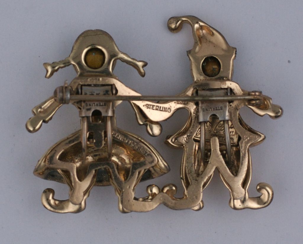 Unusual figural Coro Duette from the 1940s.Rose gold plated sterling silver with colored glass rhinestones of an amusing scandanavian? couple dressed in their winter regalia. Clips separate to be worn separately.<br />
                             
